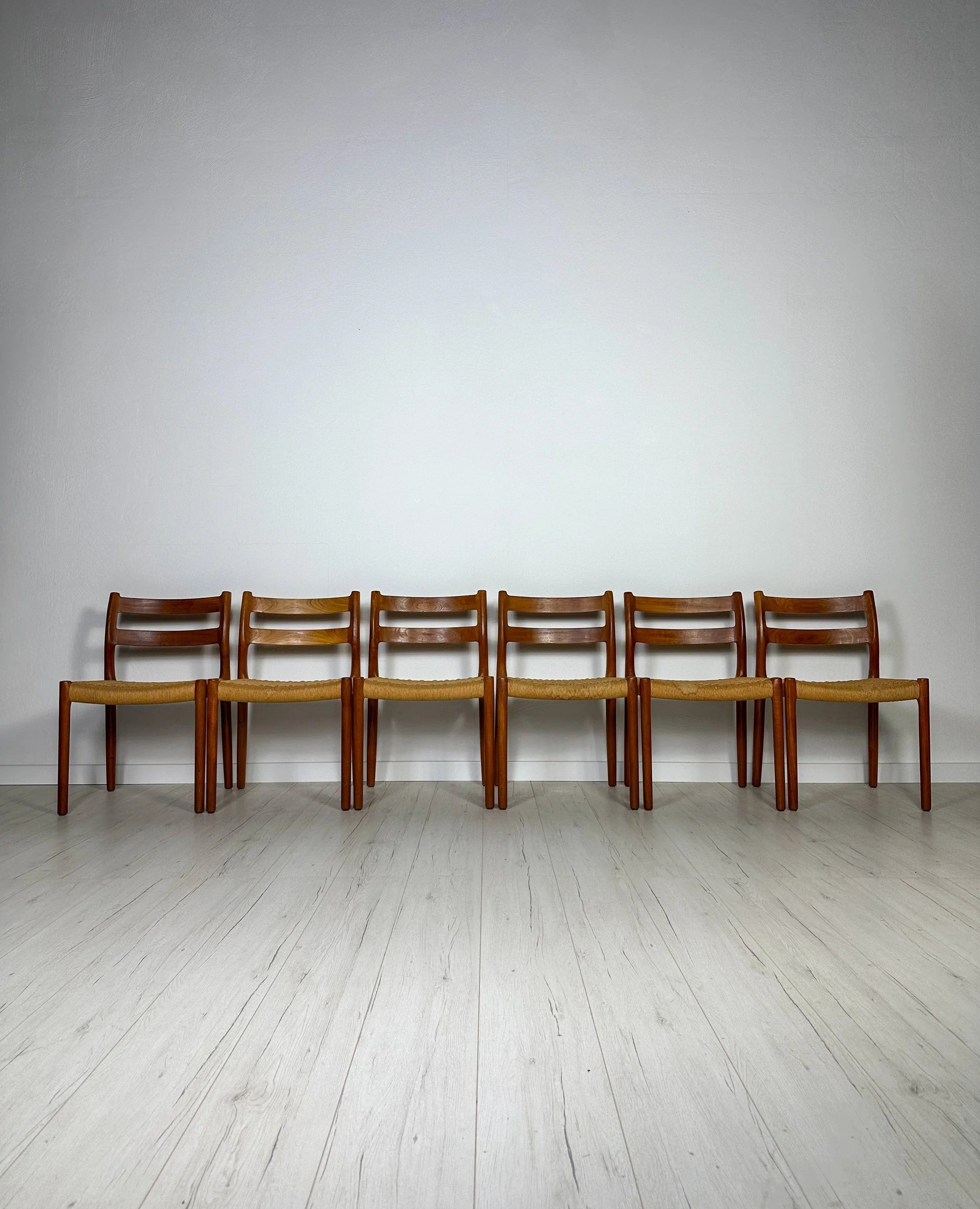 Set_of_6_Model_84_Teak_Dining_Chairs_by_Niels_Otto_Møller_for_J.L._Møller,_Papercord_Seats,_Denmark,_1960s