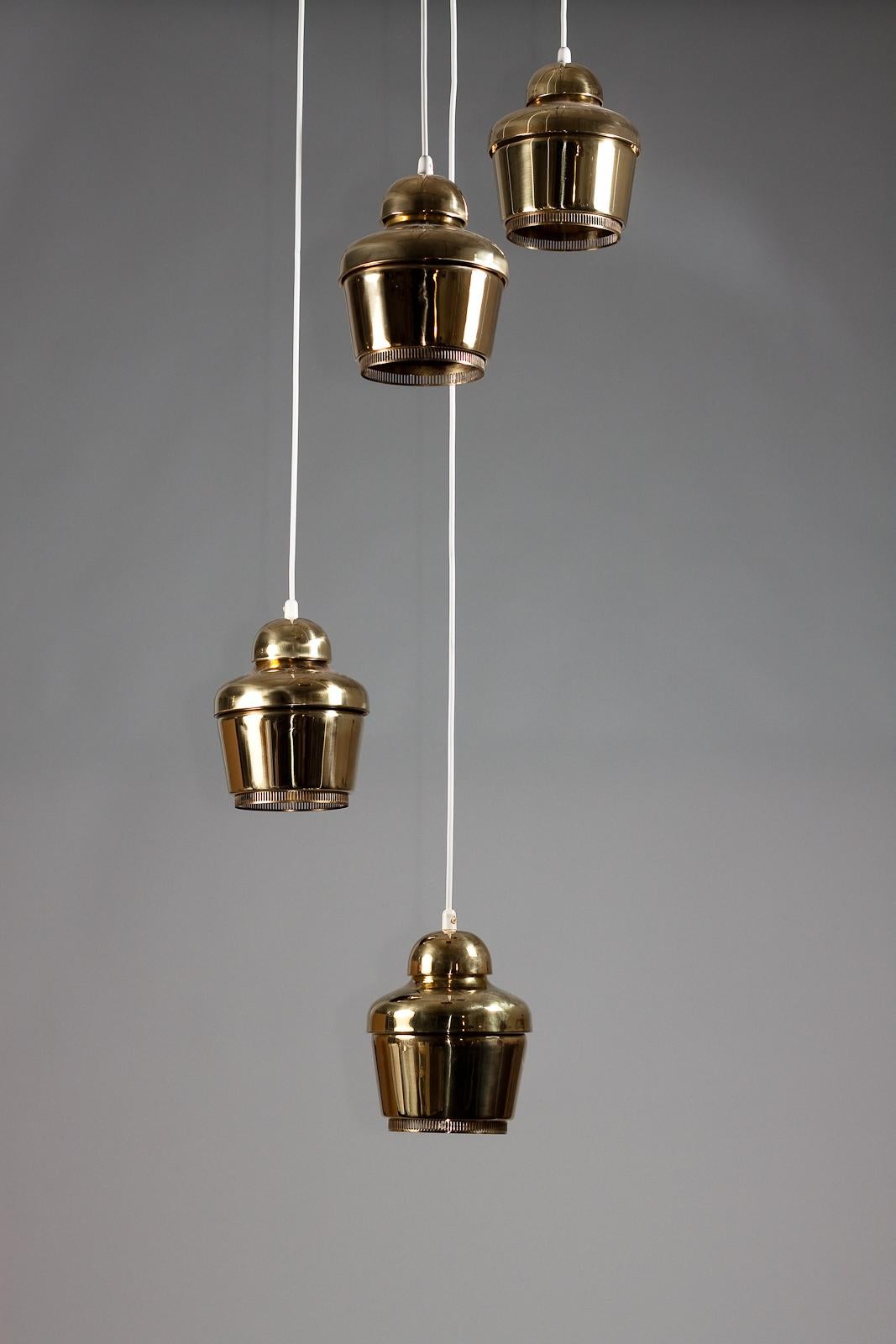 Set_of_4_Alvar_Aalto_circa_1950's_Golden_bell_A330_pendants,_Valaistustyö_Ky