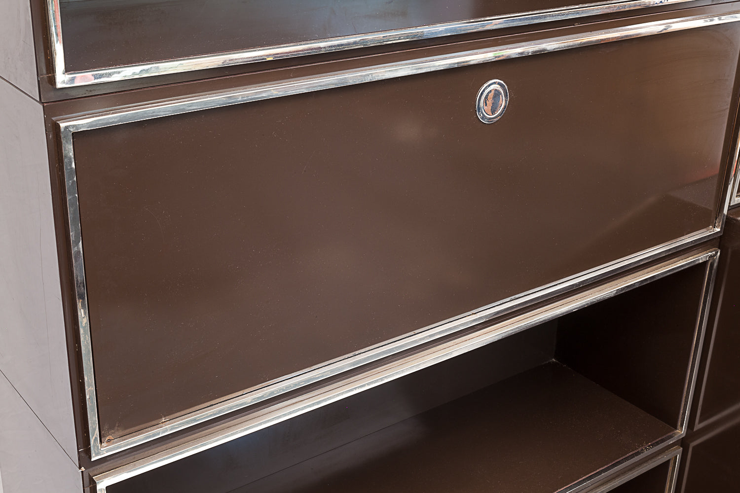 Laminated_wood_bookcase_with_chrome-plated_metal_moldings.