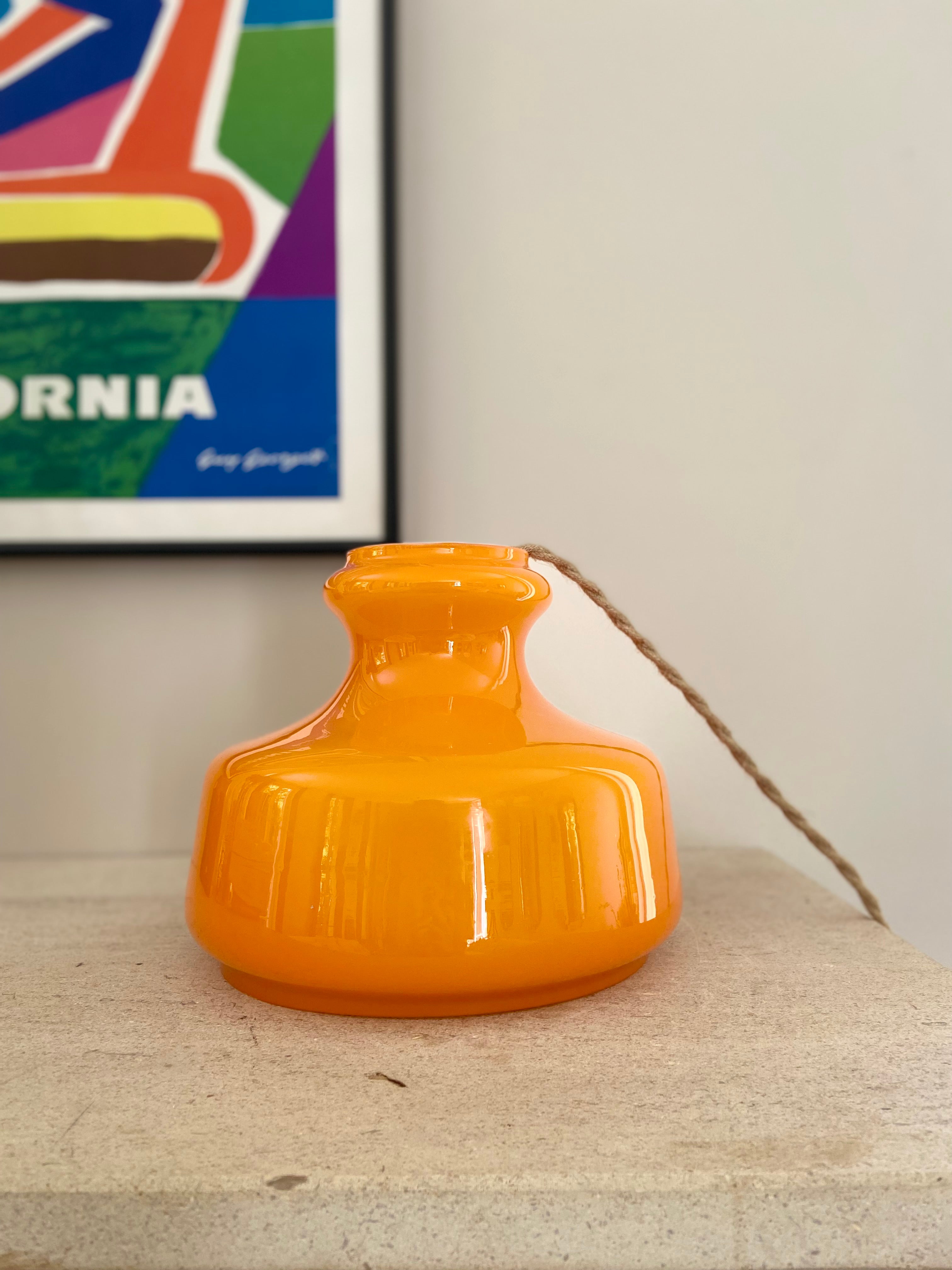 Pop_hanging_lamp_in_bright_orange_glass_from_1960