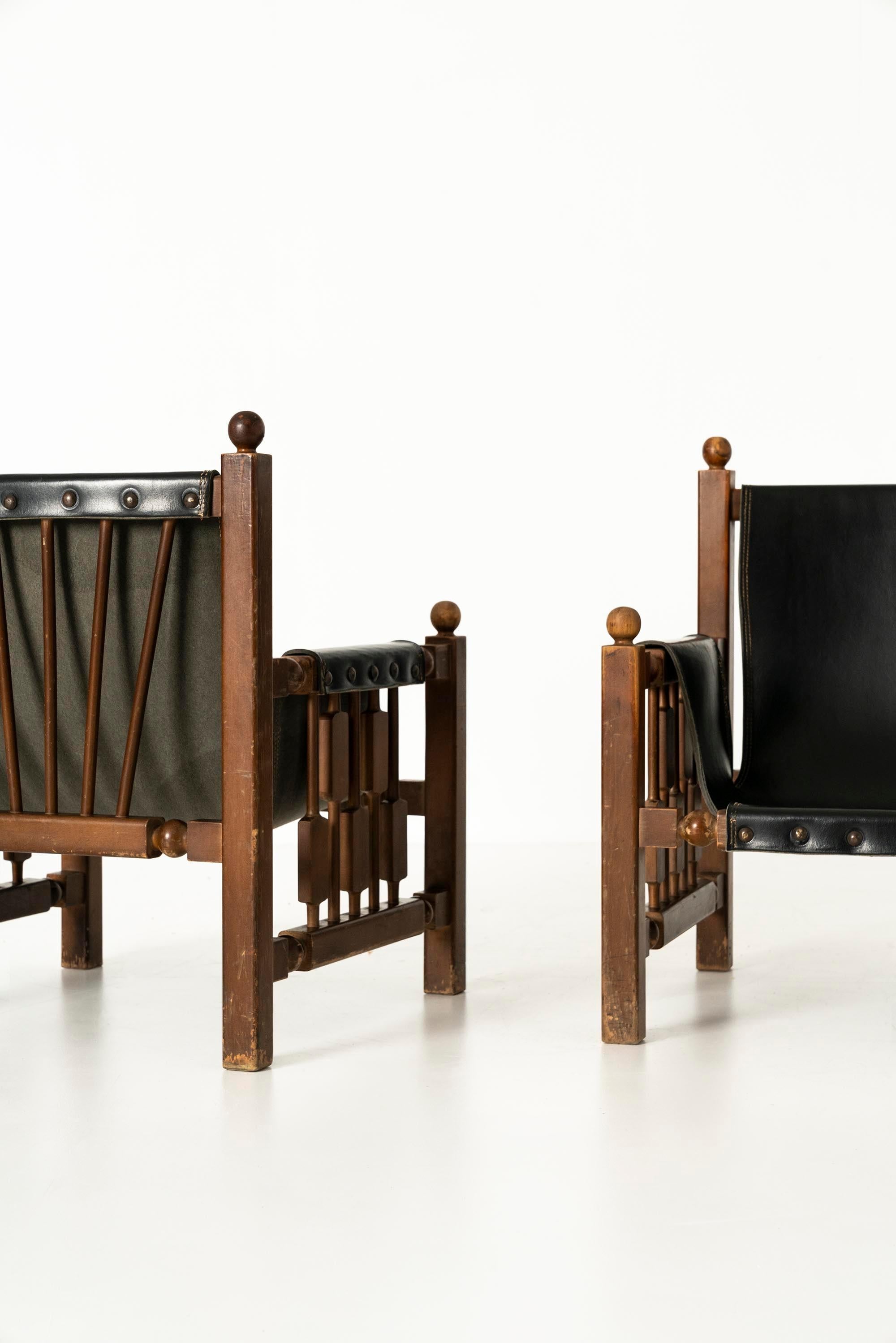 Set_of_2_Brutalist_Oak_Chairs_with_Faux_Leather_in_the_Style_of_Charles_Dudouyt_1950s