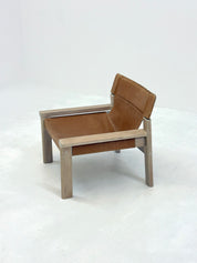 Stylish_vintage_armchair_with_saddle_leather_seat