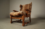 Set_of_Brutalist_Solid_Oak_Lounge_Chair_and_Matching_Ottoman_with_Original_Goat_Hide_Upholstery,_1960s