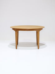 Henning_Kjaernulf_62_extendable_round_dining_table_for_Sorø_in_oak,_Denmark_1960s