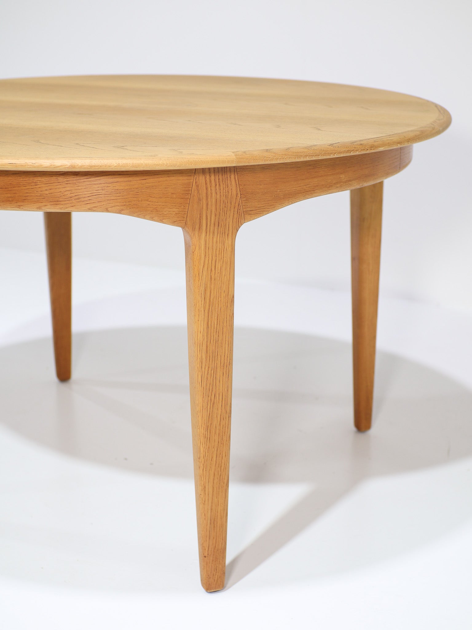 Henning_Kjaernulf_62_extendable_round_dining_table_for_Sorø_in_oak,_Denmark_1960s