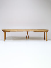 Henning_Kjaernulf_62_extendable_round_dining_table_for_Sorø_in_oak,_Denmark_1960s