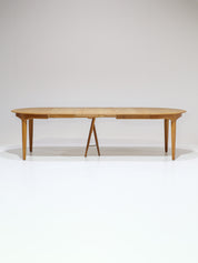 Henning_Kjaernulf_62_extendable_round_dining_table_for_Sorø_in_oak,_Denmark_1960s