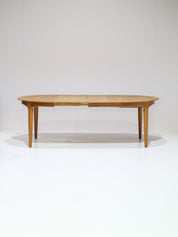 Henning_Kjaernulf_62_extendable_round_dining_table_for_Sorø_in_oak,_Denmark_1960s