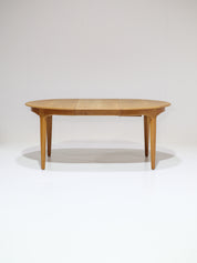 Henning_Kjaernulf_62_extendable_round_dining_table_for_Sorø_in_oak,_Denmark_1960s