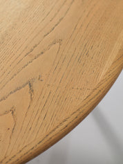 Henning_Kjaernulf_62_extendable_round_dining_table_for_Sorø_in_oak,_Denmark_1960s