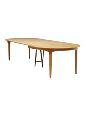 Henning_Kjaernulf_62_extendable_round_dining_table_for_Sorø_in_oak,_Denmark_1960s
