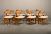 Set_of_8_Brutalist_Oak_Dining_Chairs_by_Henning_Kjærnulf_for_EG_Kvalitetsmøbel,_Off-White_Sheepskin,_Denmark,_1960s