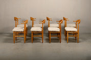 Set_of_8_Brutalist_Oak_Dining_Chairs_by_Henning_Kjærnulf_for_EG_Kvalitetsmøbel,_Off-White_Sheepskin,_Denmark,_1960s