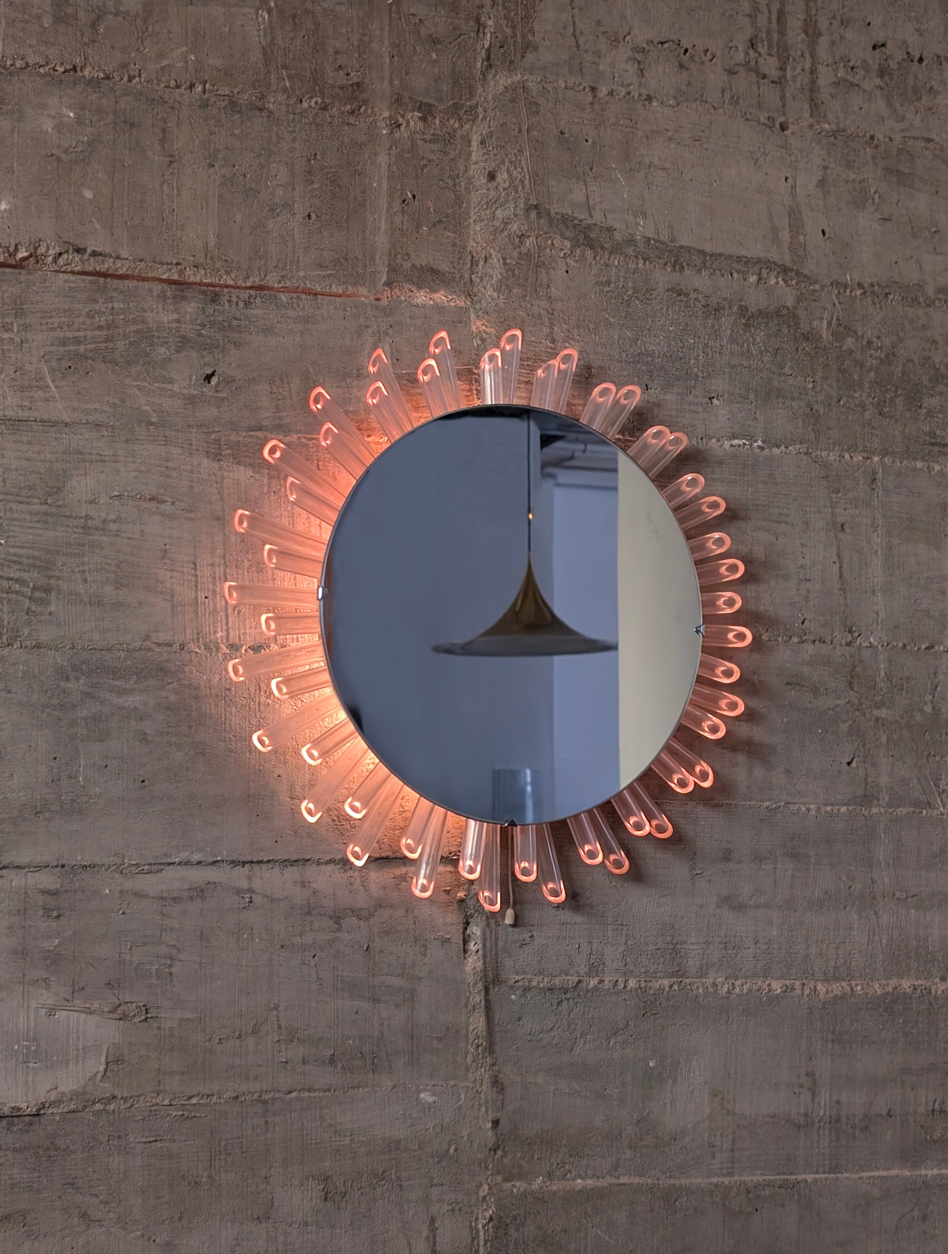 Mid-Century_Modern_Sunburst_Mirror_Wall_Lamp_in_Lucite_with_Pink_Glow,_1970s