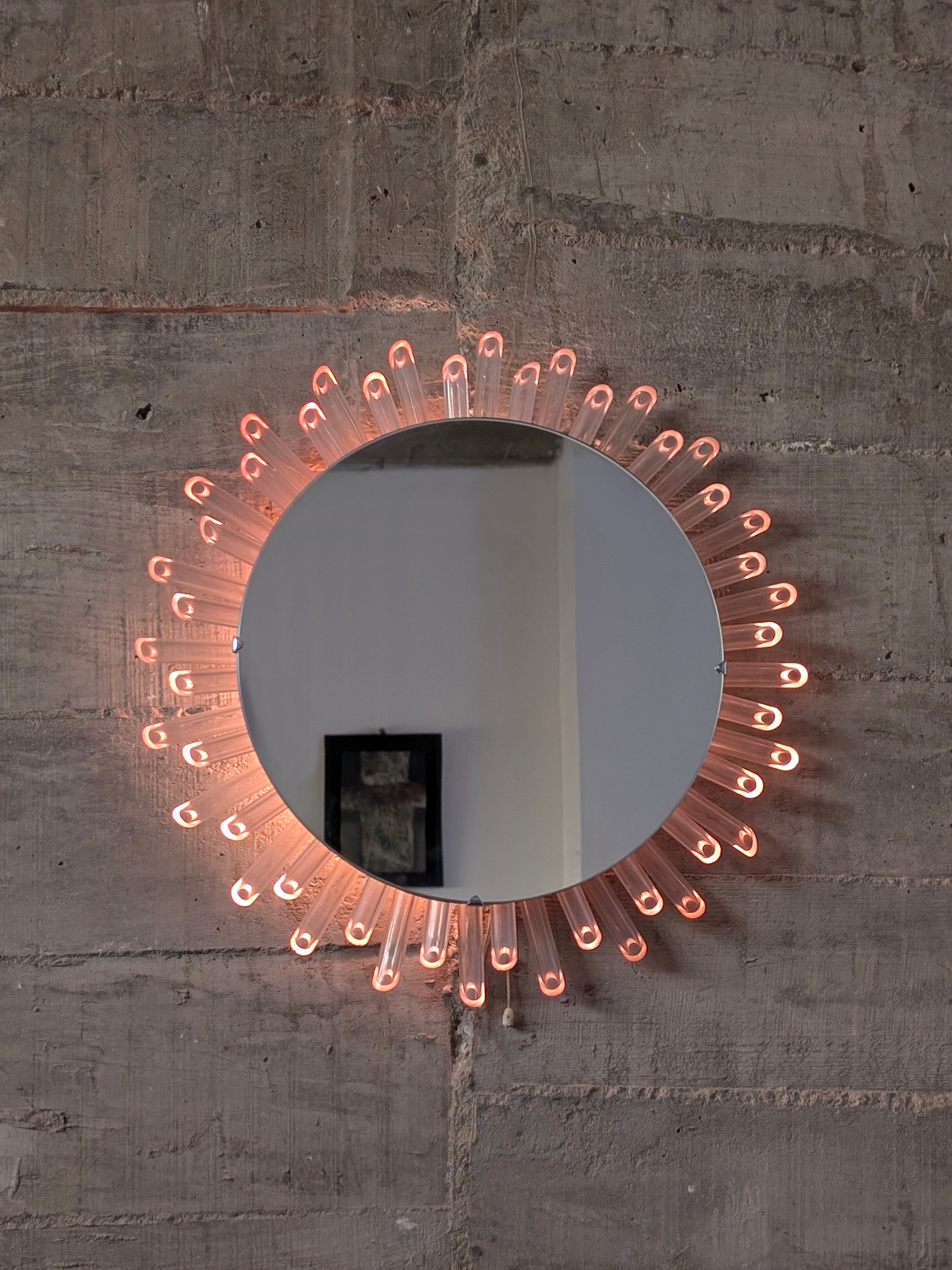 Mid-Century_Modern_Sunburst_Mirror_Wall_Lamp_in_Lucite_with_Pink_Glow,_1970s