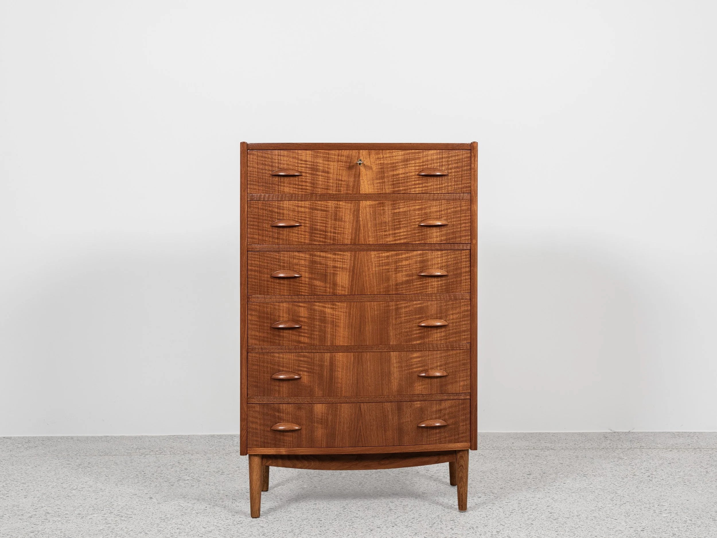 Midcentury_Danish_chest_in_teak_1960s,_bowed_front_with_half_moon_drawer_handles