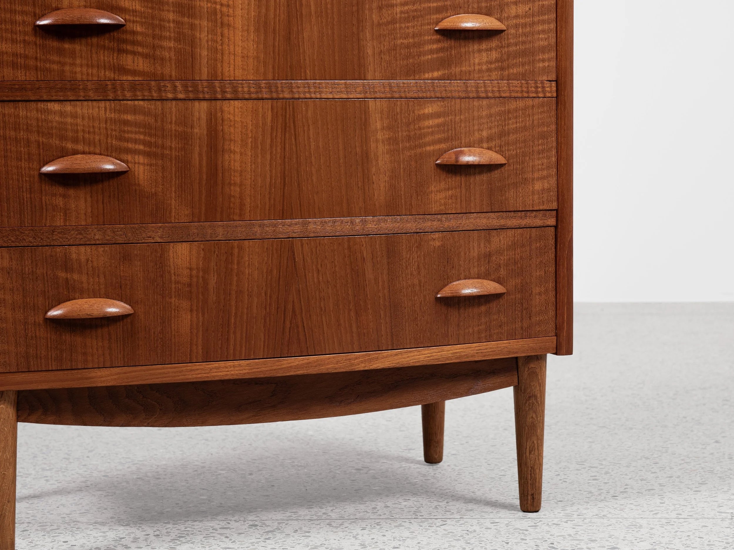 Midcentury_Danish_chest_in_teak_1960s,_bowed_front_with_half_moon_drawer_handles
