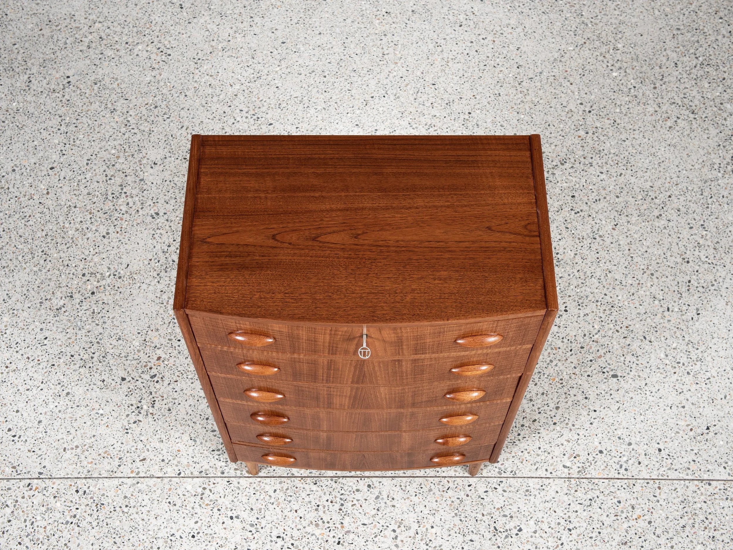 Midcentury_Danish_chest_in_teak_1960s,_bowed_front_with_half_moon_drawer_handles