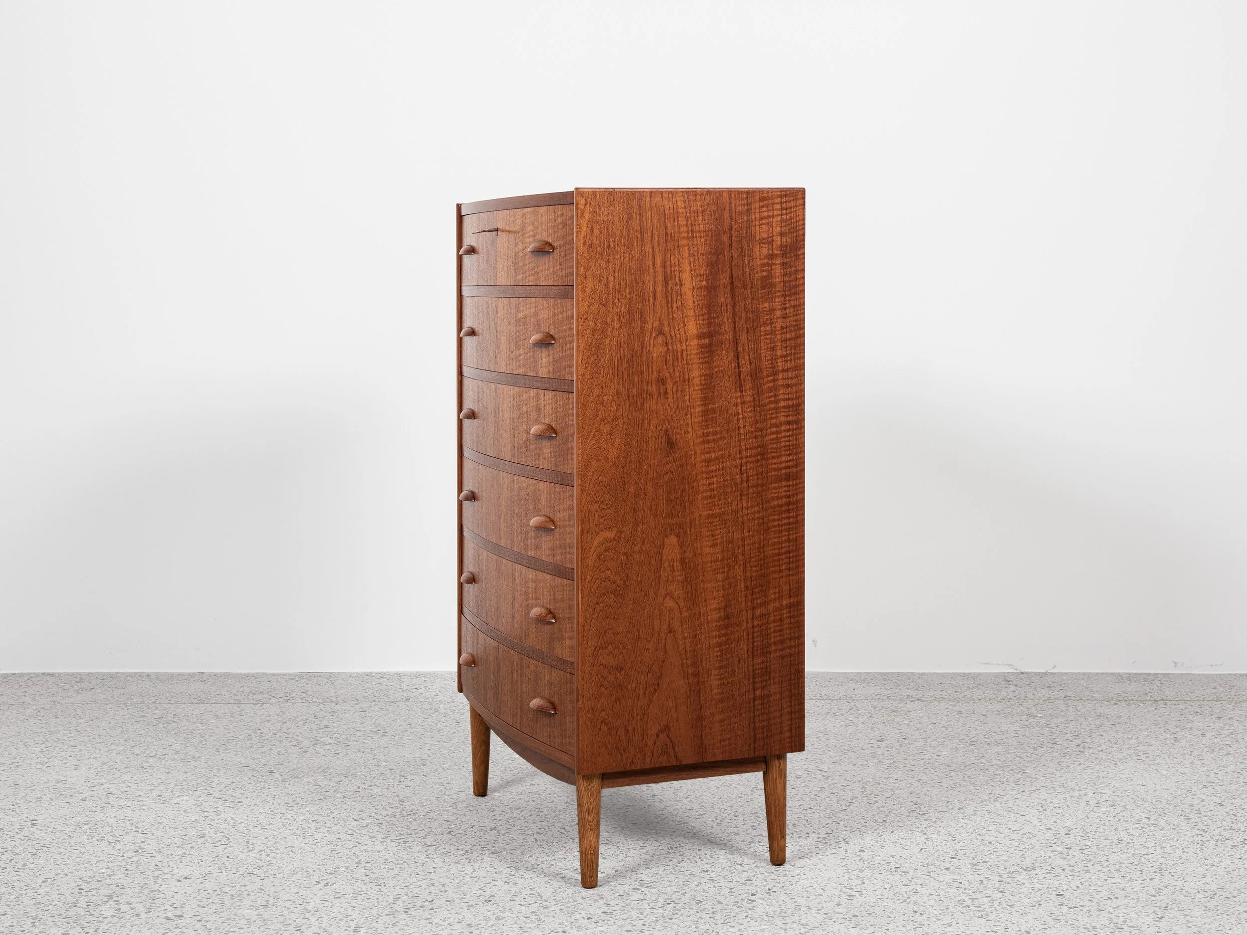 Midcentury_Danish_chest_in_teak_1960s,_bowed_front_with_half_moon_drawer_handles