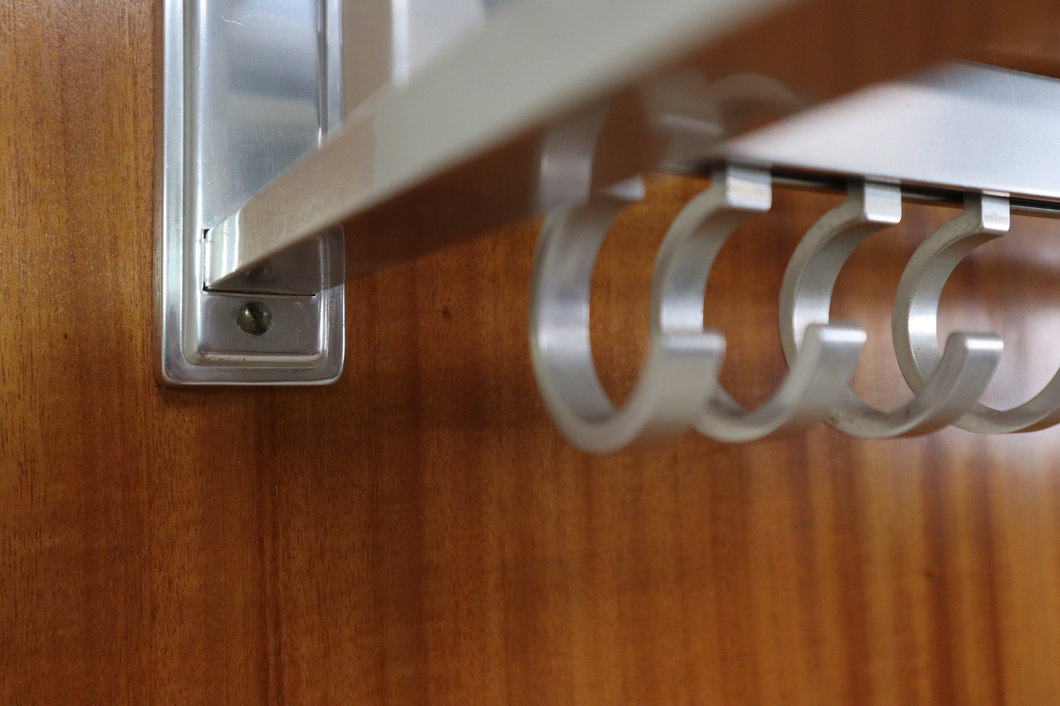 Modernist_wall-mounted_cloakroom_in_Teak,_Aluminium_&_Nickel-plated_Brass,_1950s