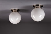 Set_of_2_Paavo_Tynell_Opaline_Glass_Sphere_Flush_Mount_Lamps,_1930s
