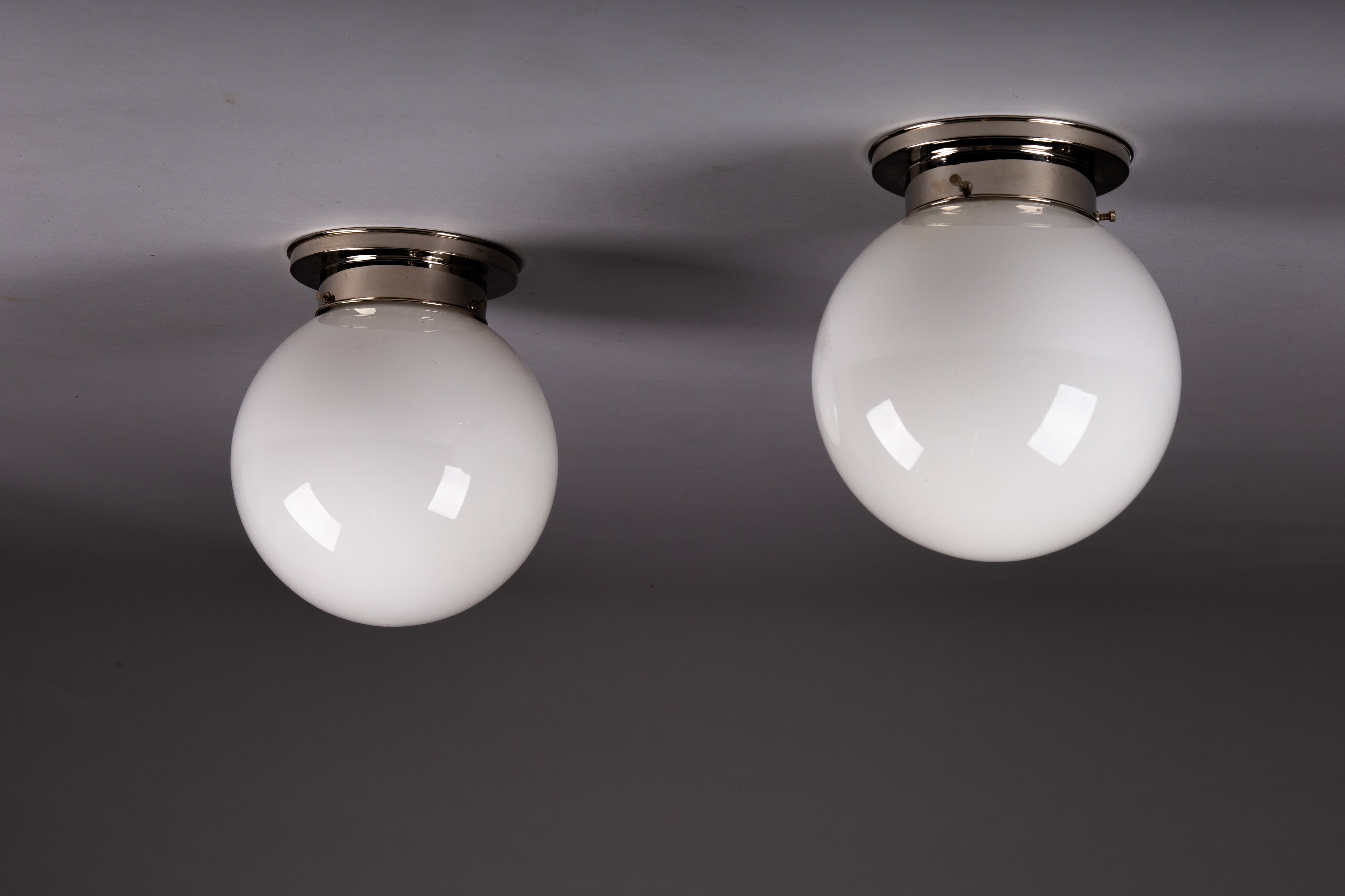 Set_of_2_Paavo_Tynell_Opaline_Glass_Sphere_Flush_Mount_Lamps,_1930s