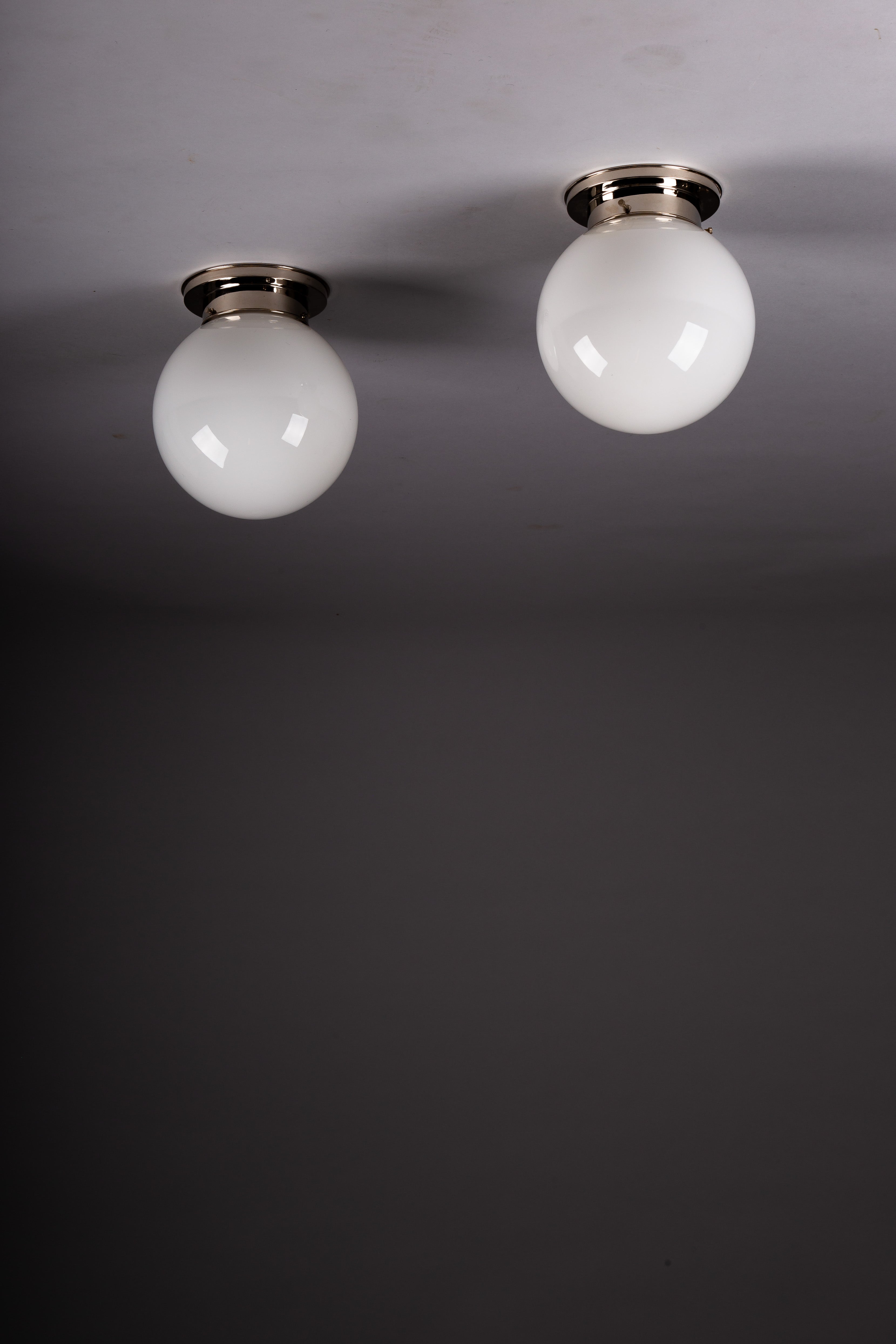 Set_of_2_Paavo_Tynell_Opaline_Glass_Sphere_Flush_Mount_Lamps,_1930s