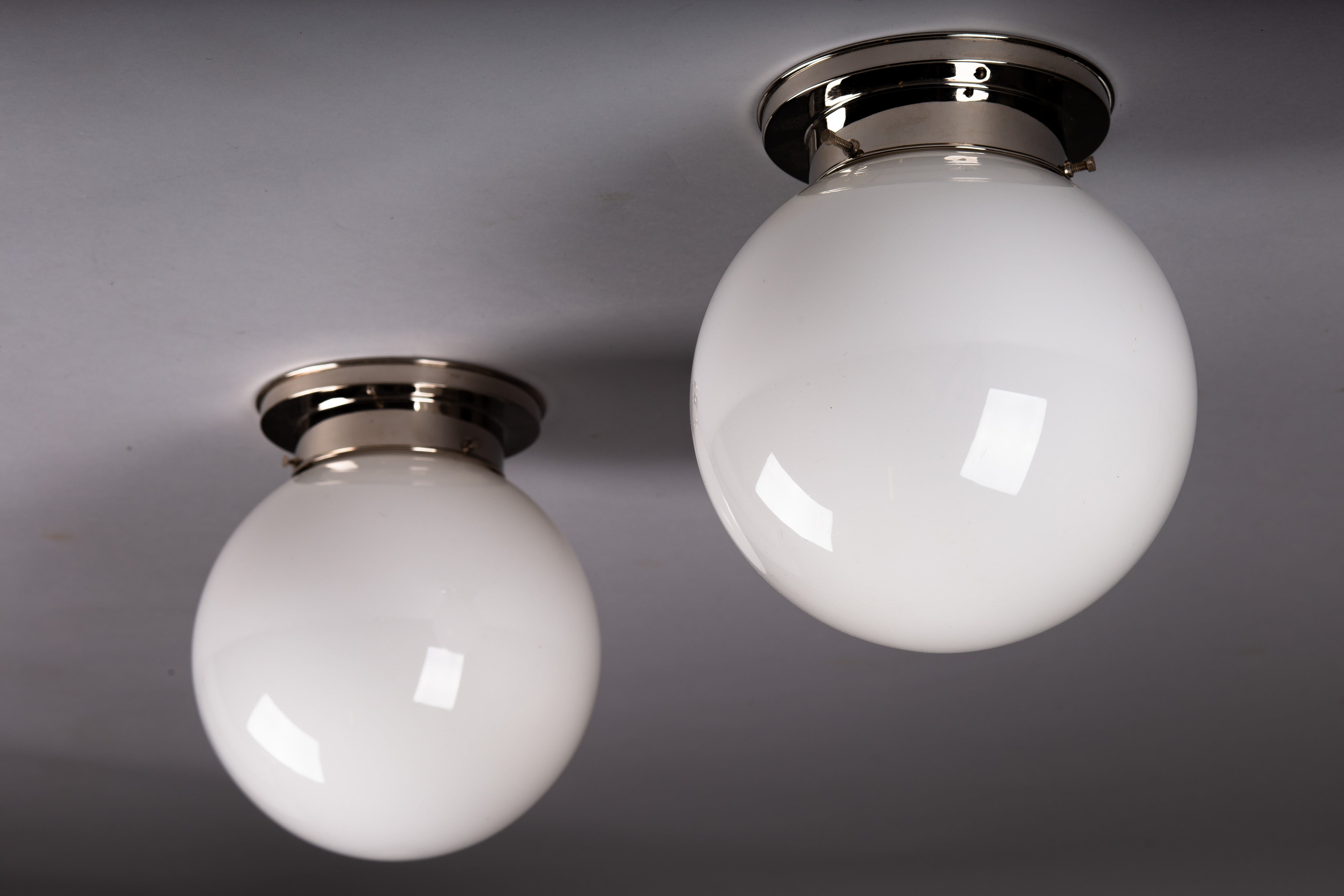 Set_of_2_Paavo_Tynell_Opaline_Glass_Sphere_Flush_Mount_Lamps,_1930s