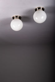 Set_of_2_Paavo_Tynell_Opaline_Glass_Sphere_Flush_Mount_Lamps,_1930s