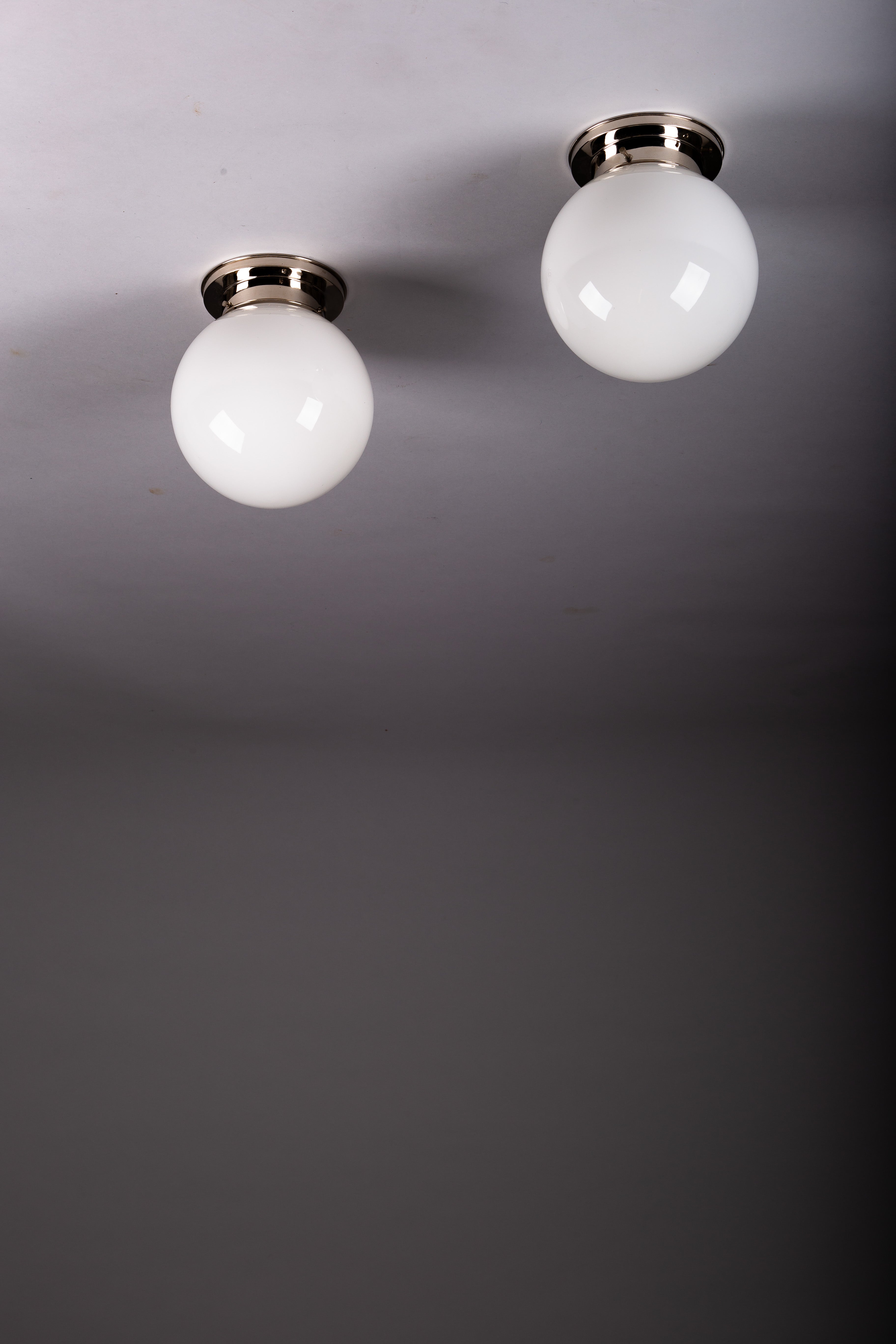 Set_of_2_Paavo_Tynell_Opaline_Glass_Sphere_Flush_Mount_Lamps,_1930s
