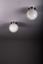 Set_of_2_Paavo_Tynell_Opaline_Glass_Sphere_Flush_Mount_Lamps,_1930s