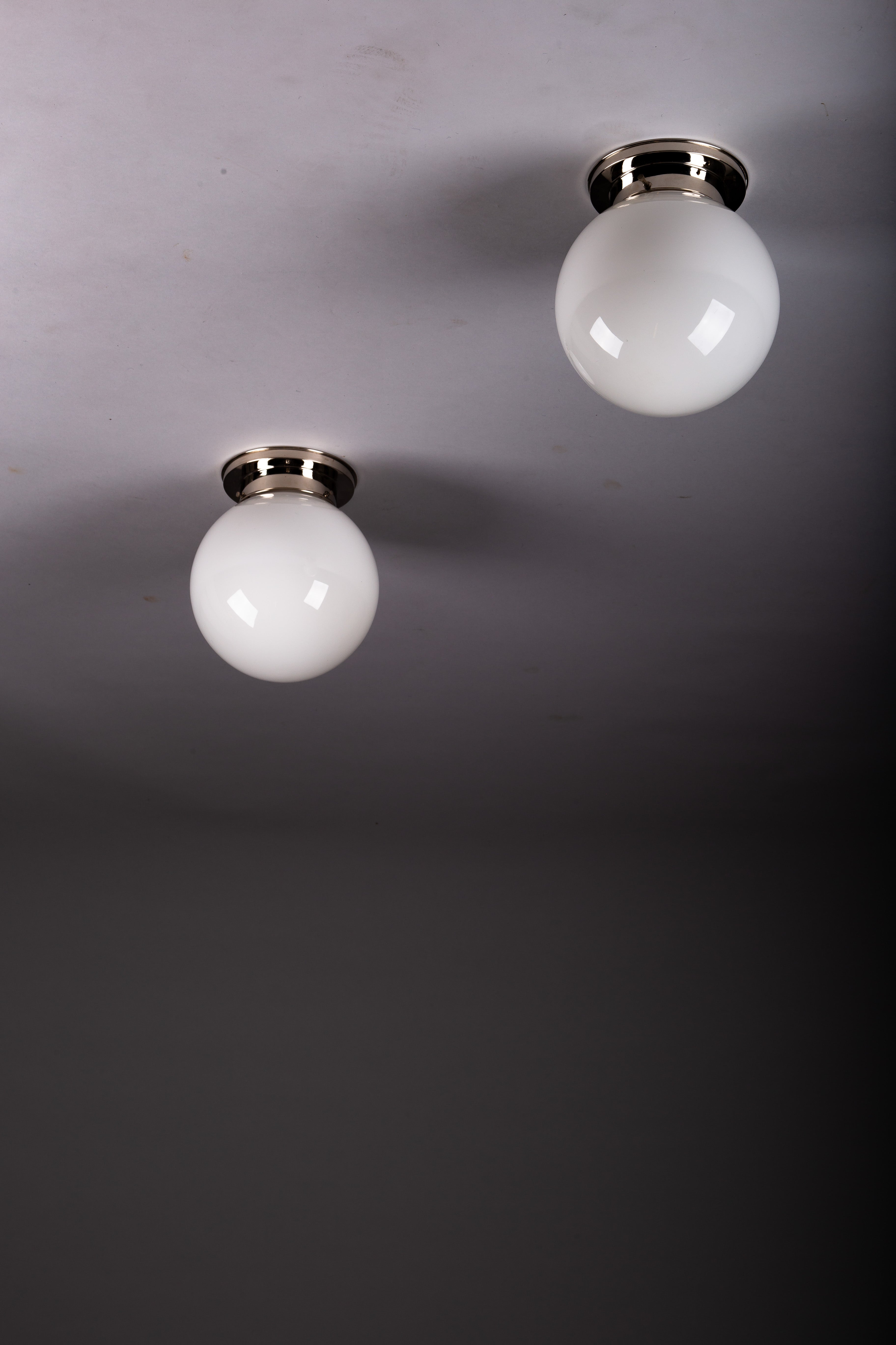 Set_of_2_Paavo_Tynell_Opaline_Glass_Sphere_Flush_Mount_Lamps,_1930s