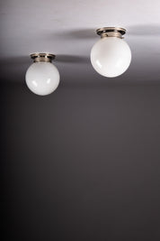 Set_of_2_Paavo_Tynell_Opaline_Glass_Sphere_Flush_Mount_Lamps,_1930s