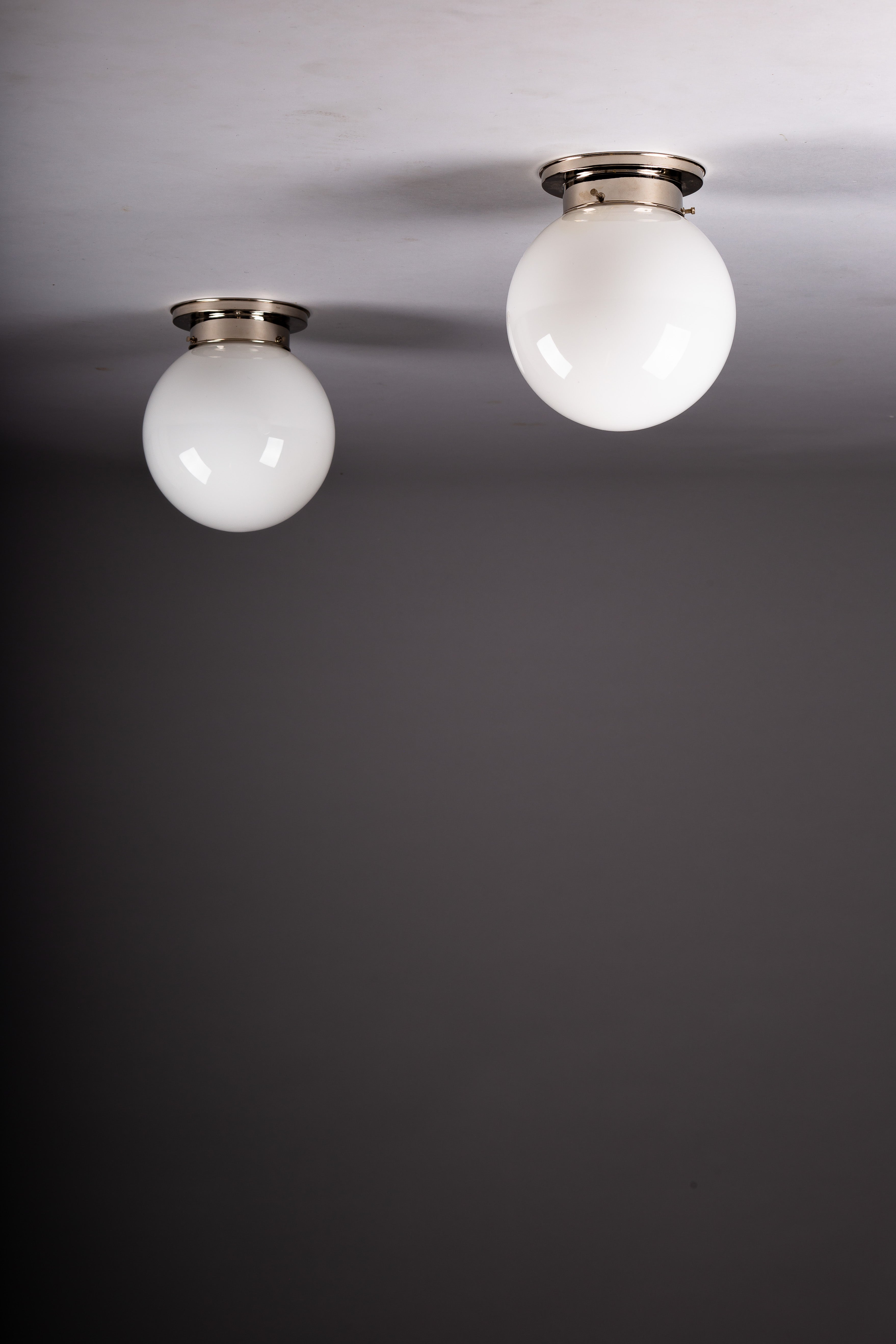 Set_of_2_Paavo_Tynell_Opaline_Glass_Sphere_Flush_Mount_Lamps,_1930s