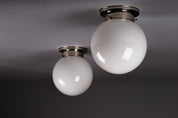 Set_of_2_Paavo_Tynell_Opaline_Glass_Sphere_Flush_Mount_Lamps,_1930s
