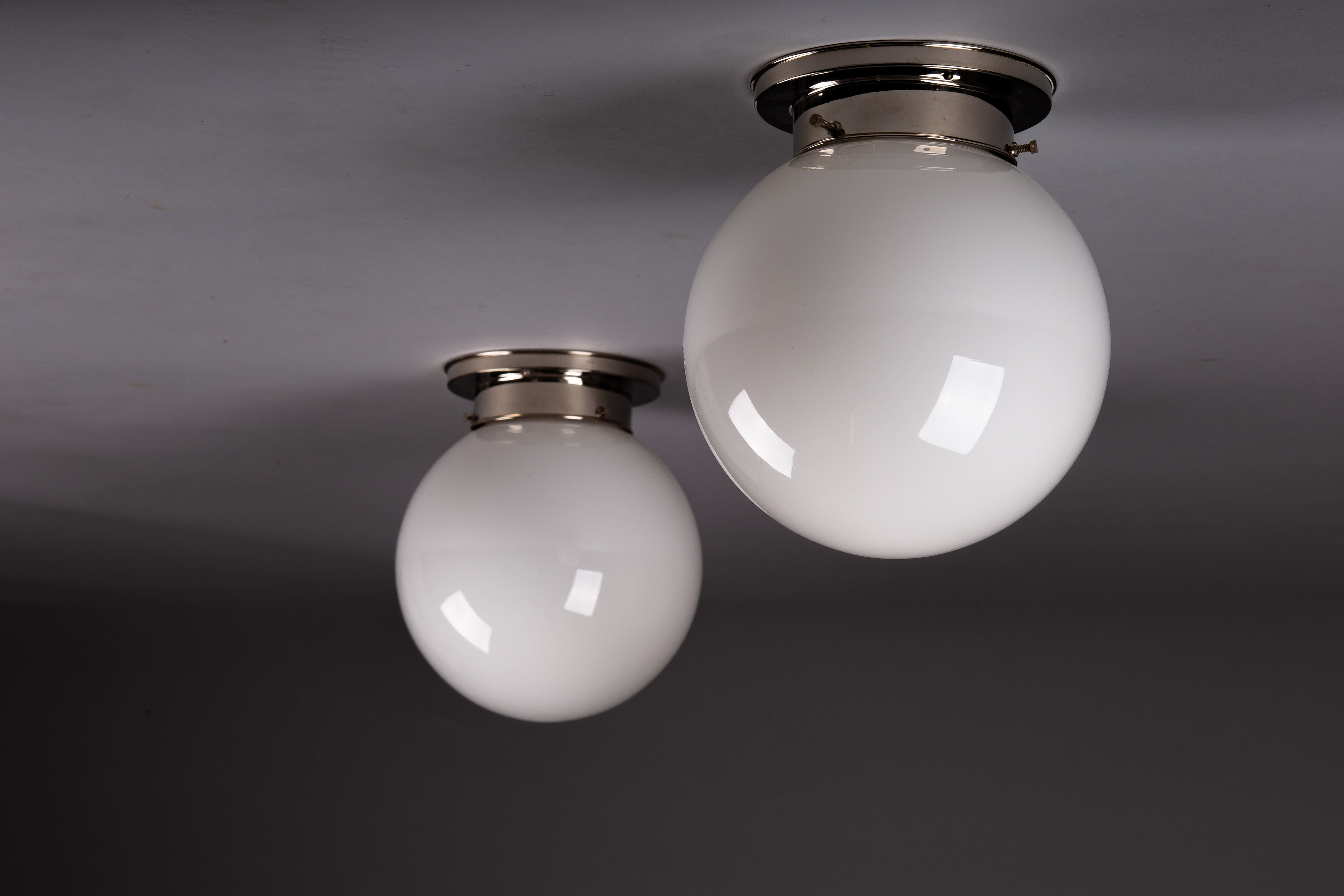 Set_of_2_Paavo_Tynell_Opaline_Glass_Sphere_Flush_Mount_Lamps,_1930s