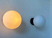 Set_of_2_Opaline_Glass_and_Bakelite_Wall_Sconces_by_RAAK,_Netherlands_1970s