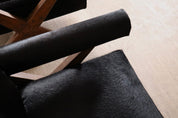 Set_of_2_Pierre_Jeanneret_PJ-SI-48-A_X-Leg_Lounge_Chairs_in_Teak_and_Black_Pony,_Chandigarh,_circa_1960