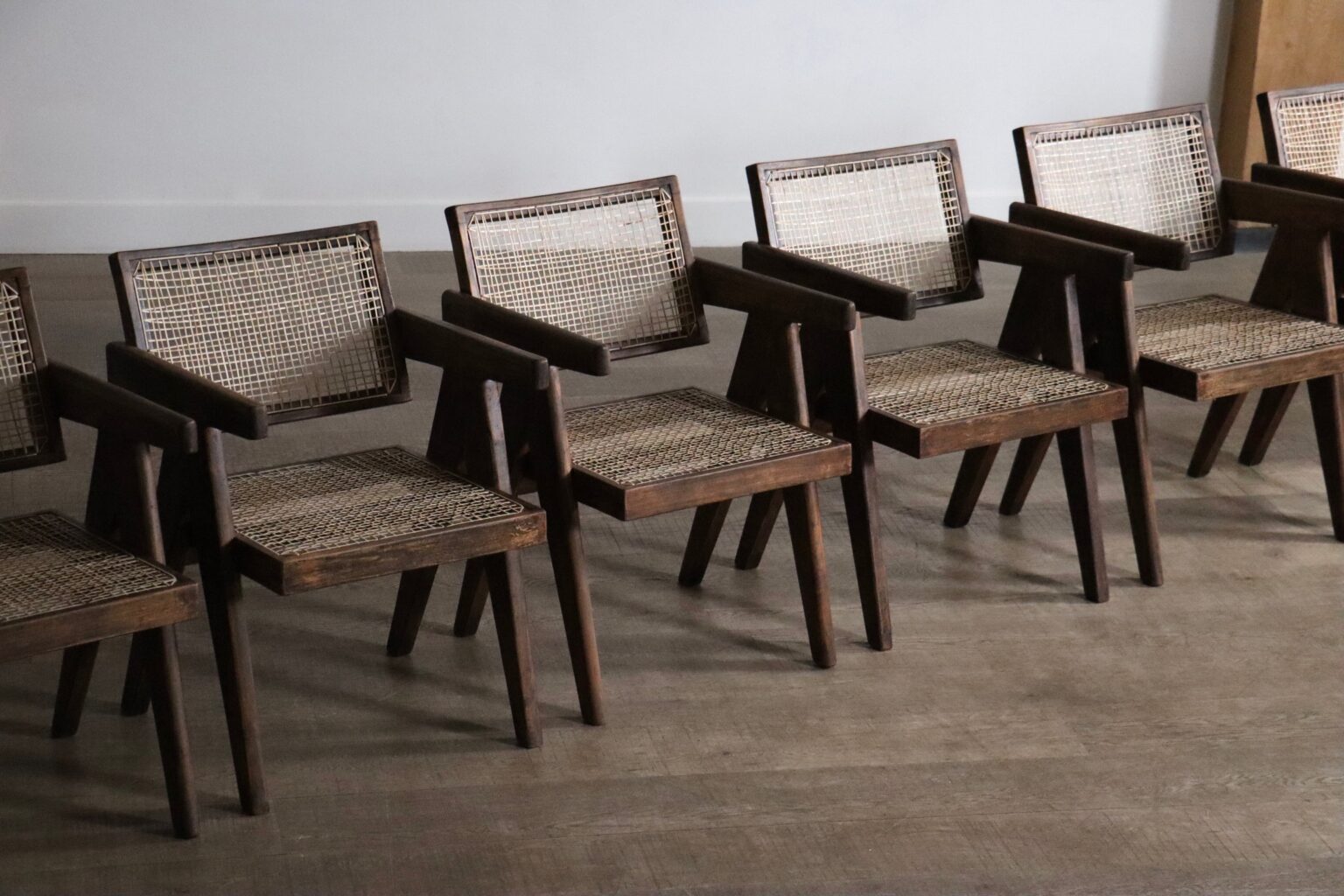 Set_of_8_Pierre_Jeanneret_Office_Cane_Chairs_in_Teak,_Chandigarh,_India,_1950s
