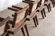 Set_of_8_Pierre_Jeanneret_Office_Cane_Chairs,_India_1950s