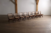 Set_of_8_Pierre_Jeanneret_PJ-SI-25-A_Student_Chairs_in_Teak_and_Cane,_Chandigarh,_1958–59