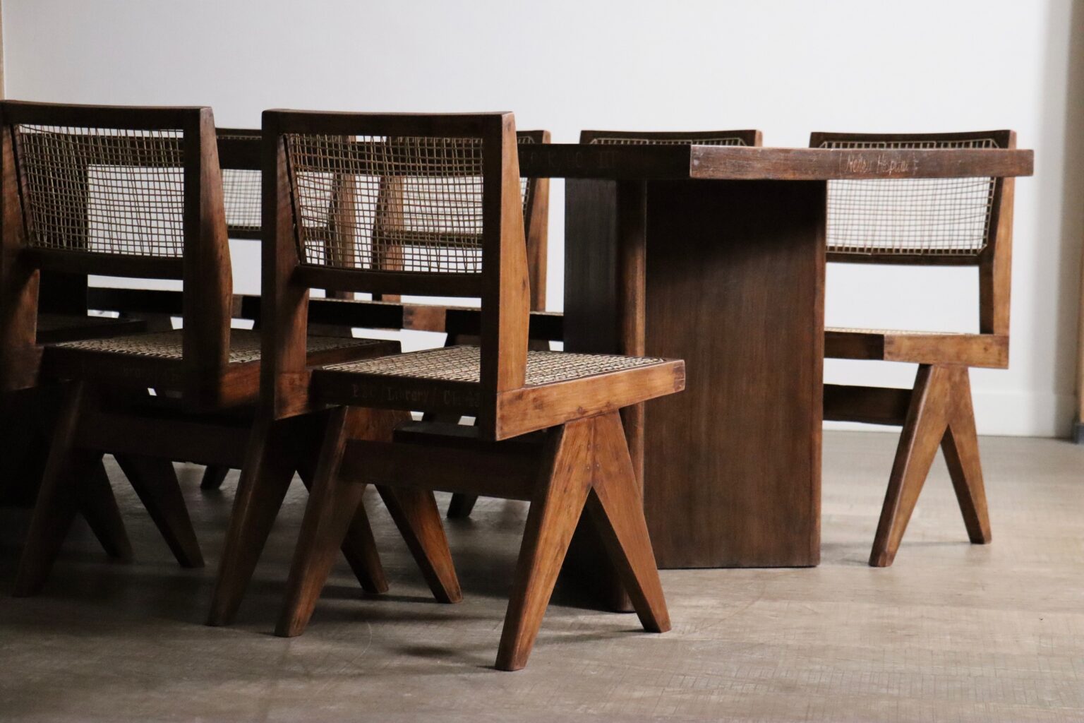 Set_of_8_Pierre_Jeanneret_PJ-SI-25-A_Student_Chairs_in_Teak_and_Cane,_Chandigarh,_1958–59