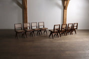 Set_of_8_Pierre_Jeanneret_PJ-SI-25-A_Student_Chairs_in_Teak_and_Cane,_Chandigarh,_1958–59