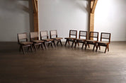 Set_of_8_Pierre_Jeanneret_PJ-SI-25-A_Student_Chairs_in_Teak_and_Cane,_Chandigarh,_1958–59