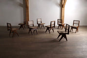 Set_of_8_Pierre_Jeanneret_PJ-SI-25-A_Student_Chairs_in_Teak_and_Cane,_Chandigarh,_1958–59