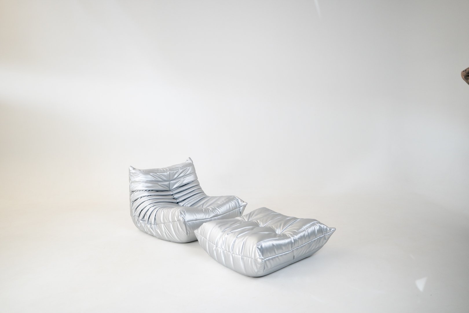 Set_of_Togo_Lounge_Chair_and_Pouf_by_Michel_Ducaroy_for_Ligne_Roset,_Silver_Skai,_France,_1973