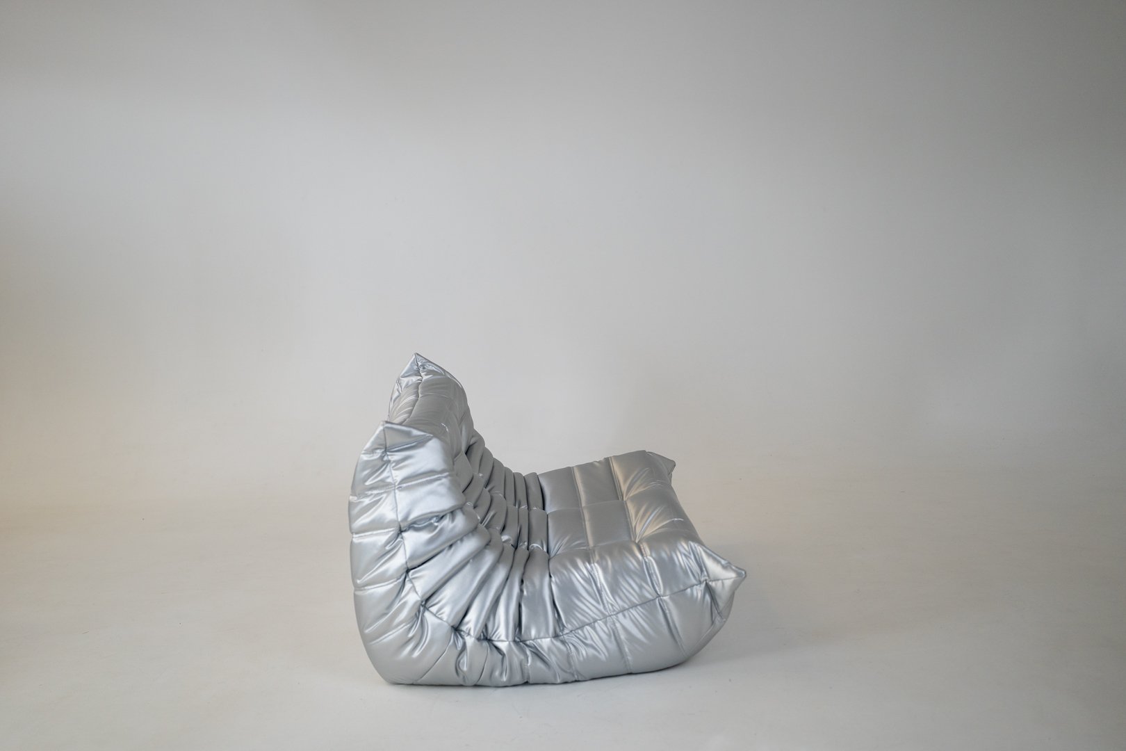 Set_of_Togo_Lounge_Chair_and_Pouf_by_Michel_Ducaroy_for_Ligne_Roset,_Silver_Skai,_France,_1973