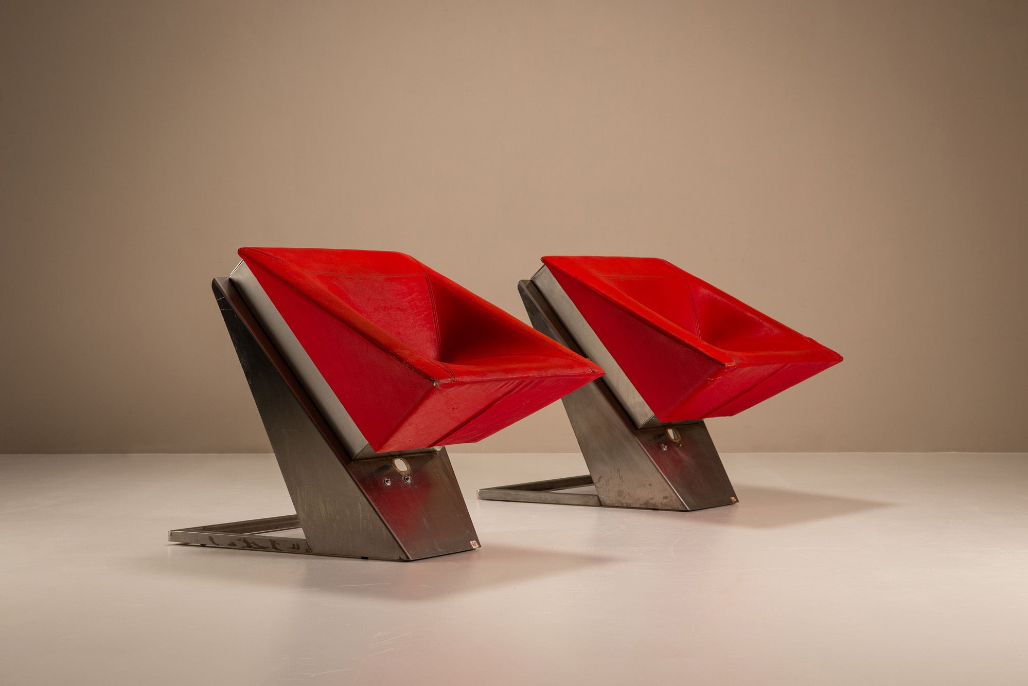 Set_of_2_Sculptural_Lounge_Chairs,_Metal_And_Red_Leather,_1960s,_Italy