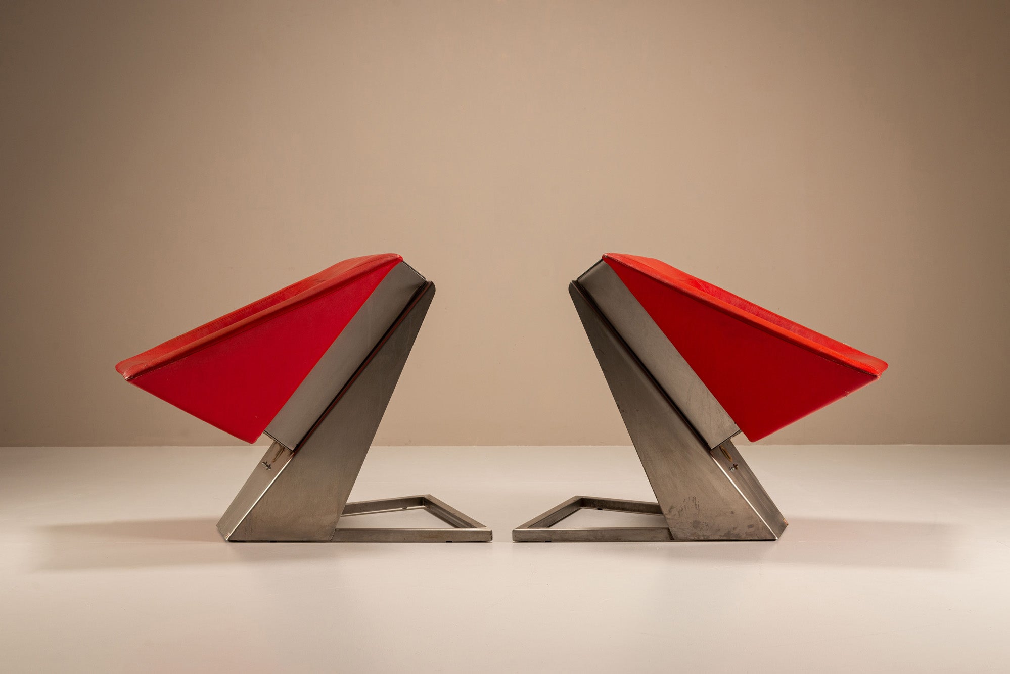 Set_of_2_Sculptural_Lounge_Chairs,_Metal_And_Red_Leather,_1960s,_Italy