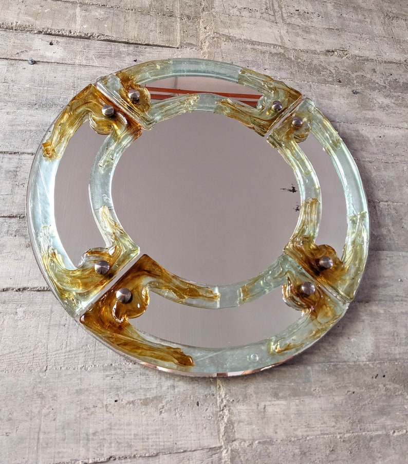Venetian_round_mirror_in_amber_murano_glass_by_Mazzega_from_1960s